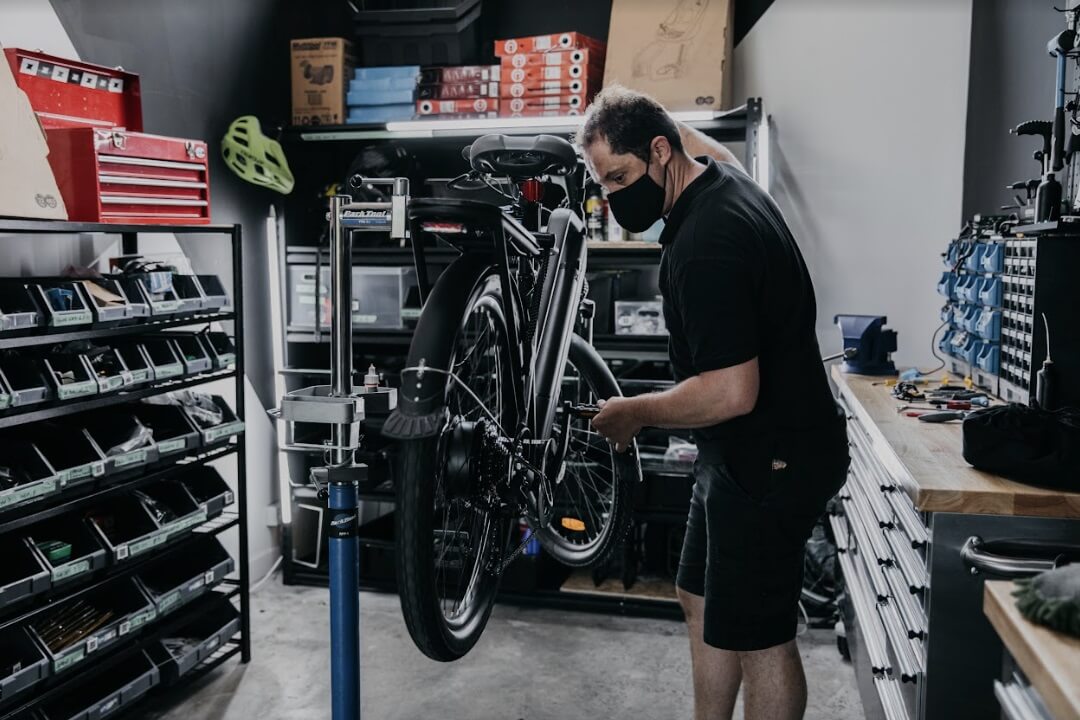 Zoomo mechanic servicing a refurbished e-bike in the workshop