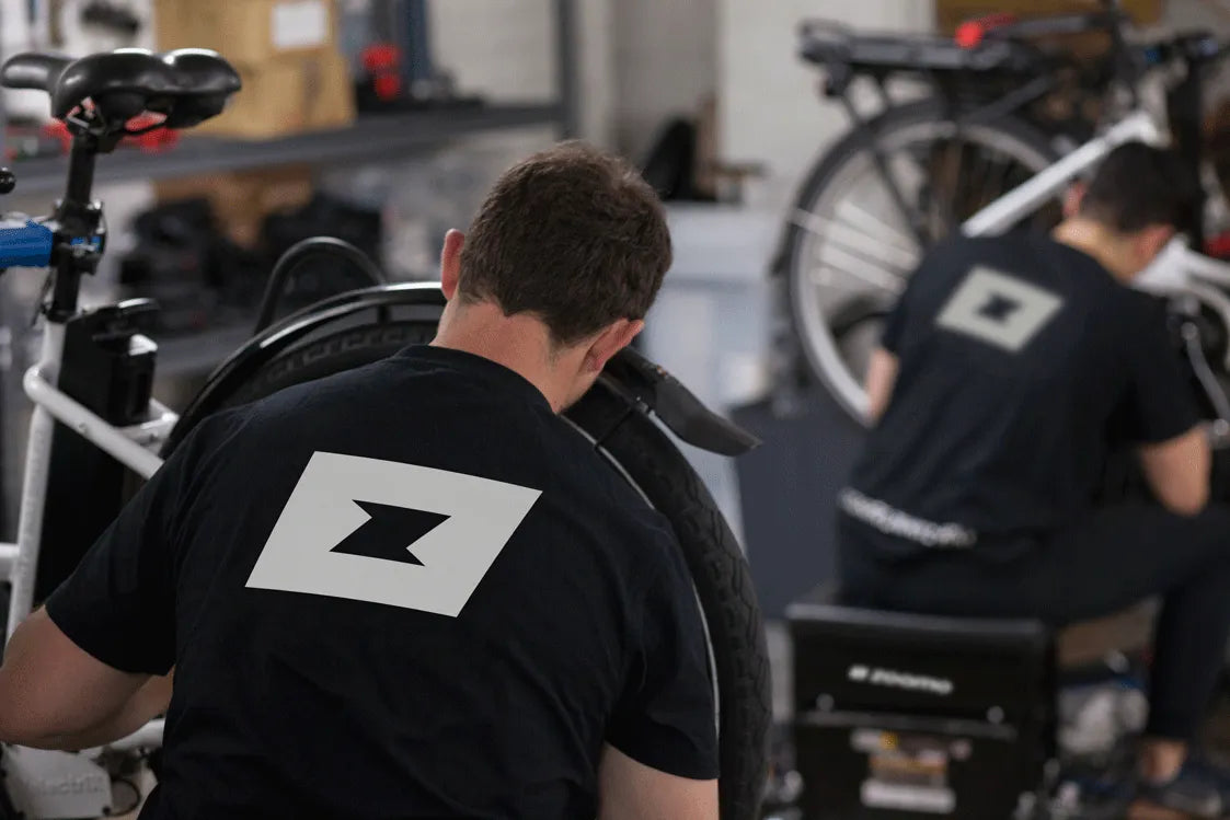 Zoomo workshop mechanics working on e-bikes